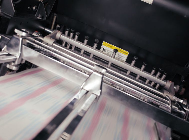Blurred paper in motion during printing process.